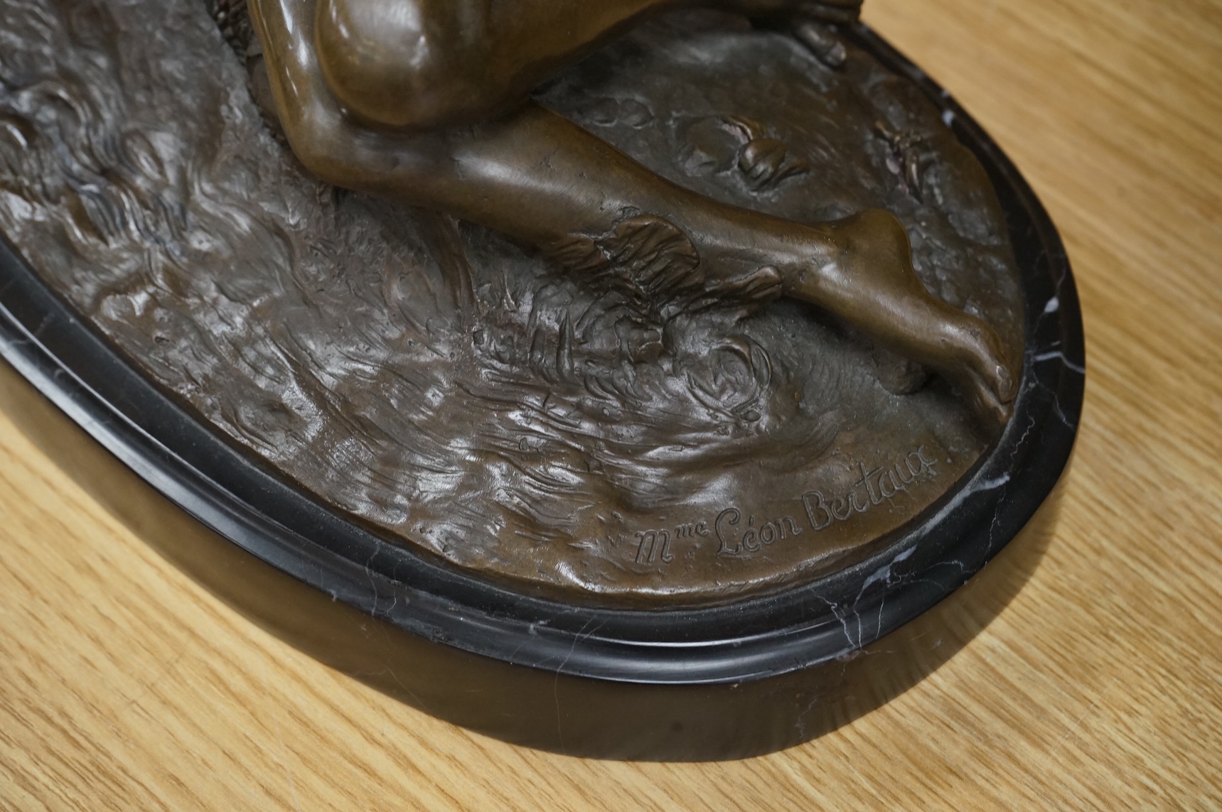 After Mme Leon Bertaux, bronze of a female reclining nude with butterfly, 28cm wide x 27cm high.